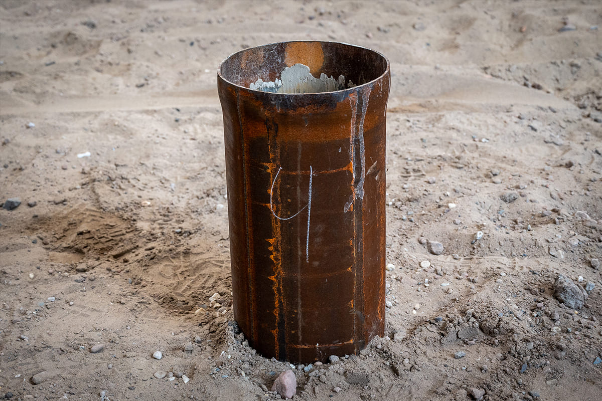 Swaged foundation tube in the ground